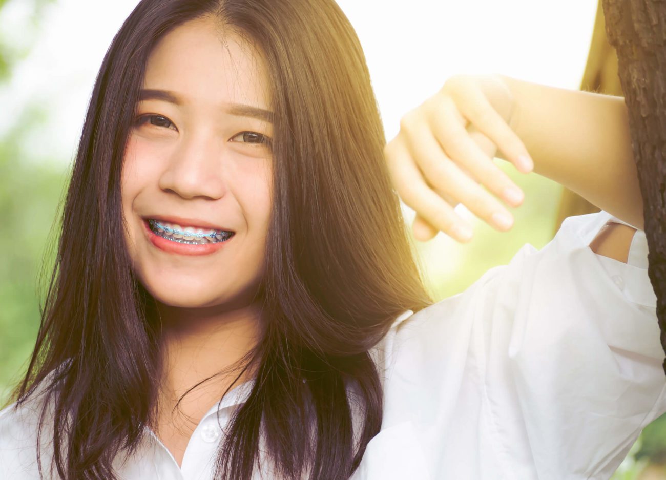 smiling girl tooth extraction for braces timonium md